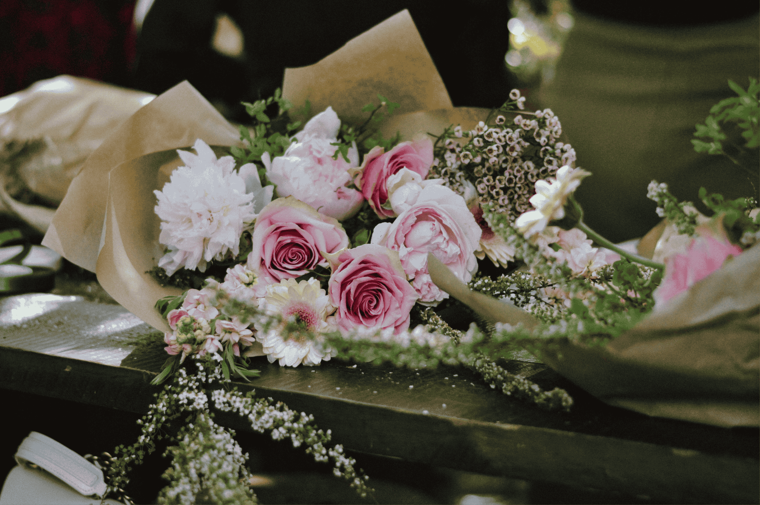 Pink and white flower bouquet with kraft paper wrapping by Studley Flower Gardens