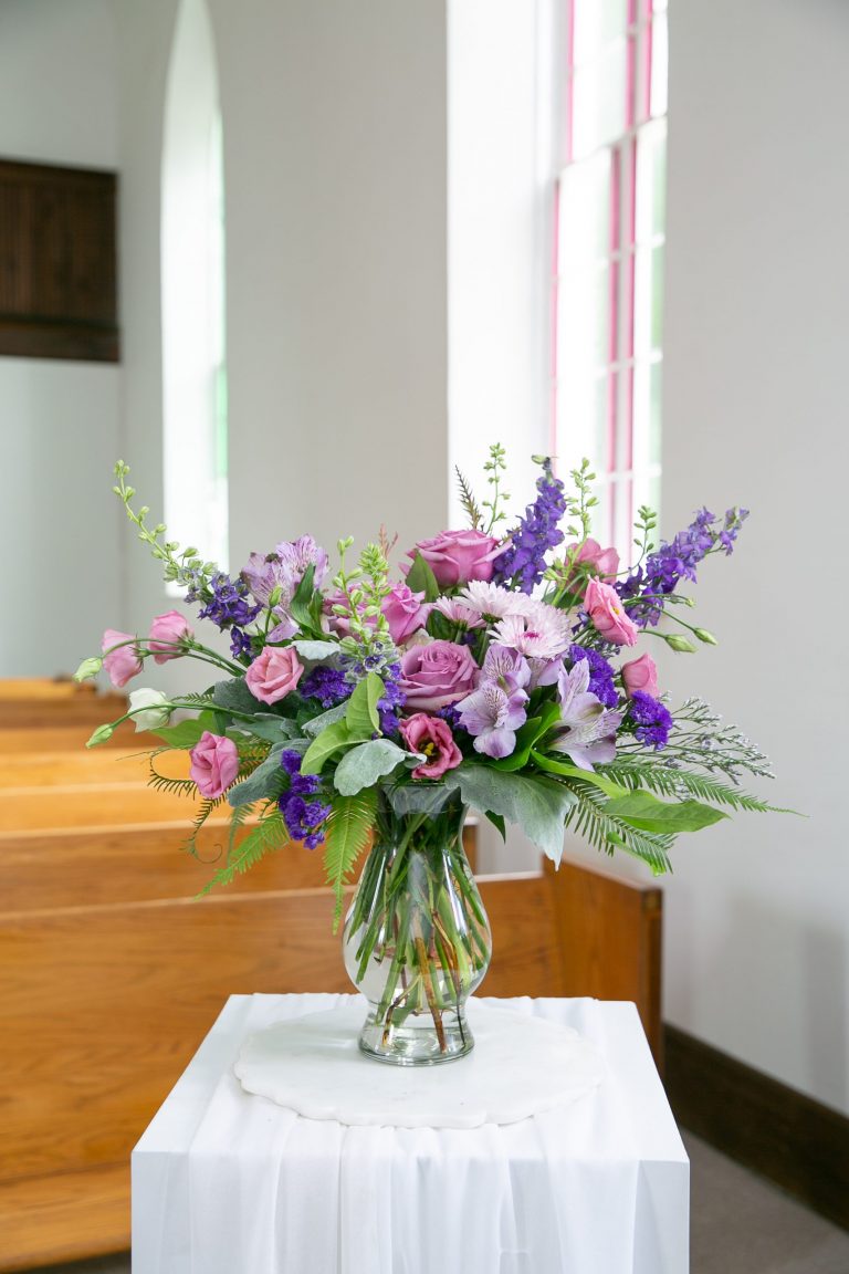Amethyst tribute bouquet with lavender roses and chrysanthemums in glass vase by Studley Flower Gardens