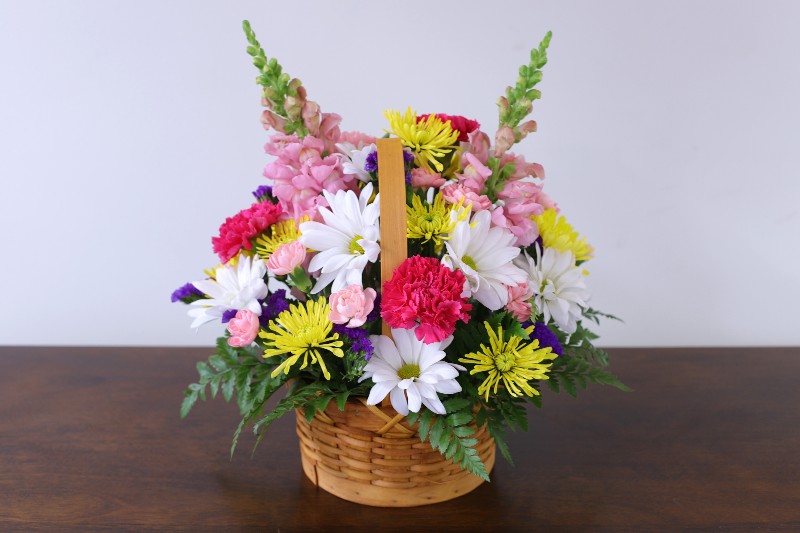 Cherished Spirit Bouquet in wicker basket with handle by Studley Flower Gardens