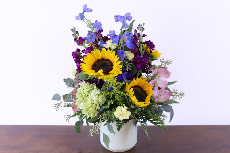 Cottage Meadow Bouquet by Studley’s with sunflowers and delphinium by Studley Flower Gardens