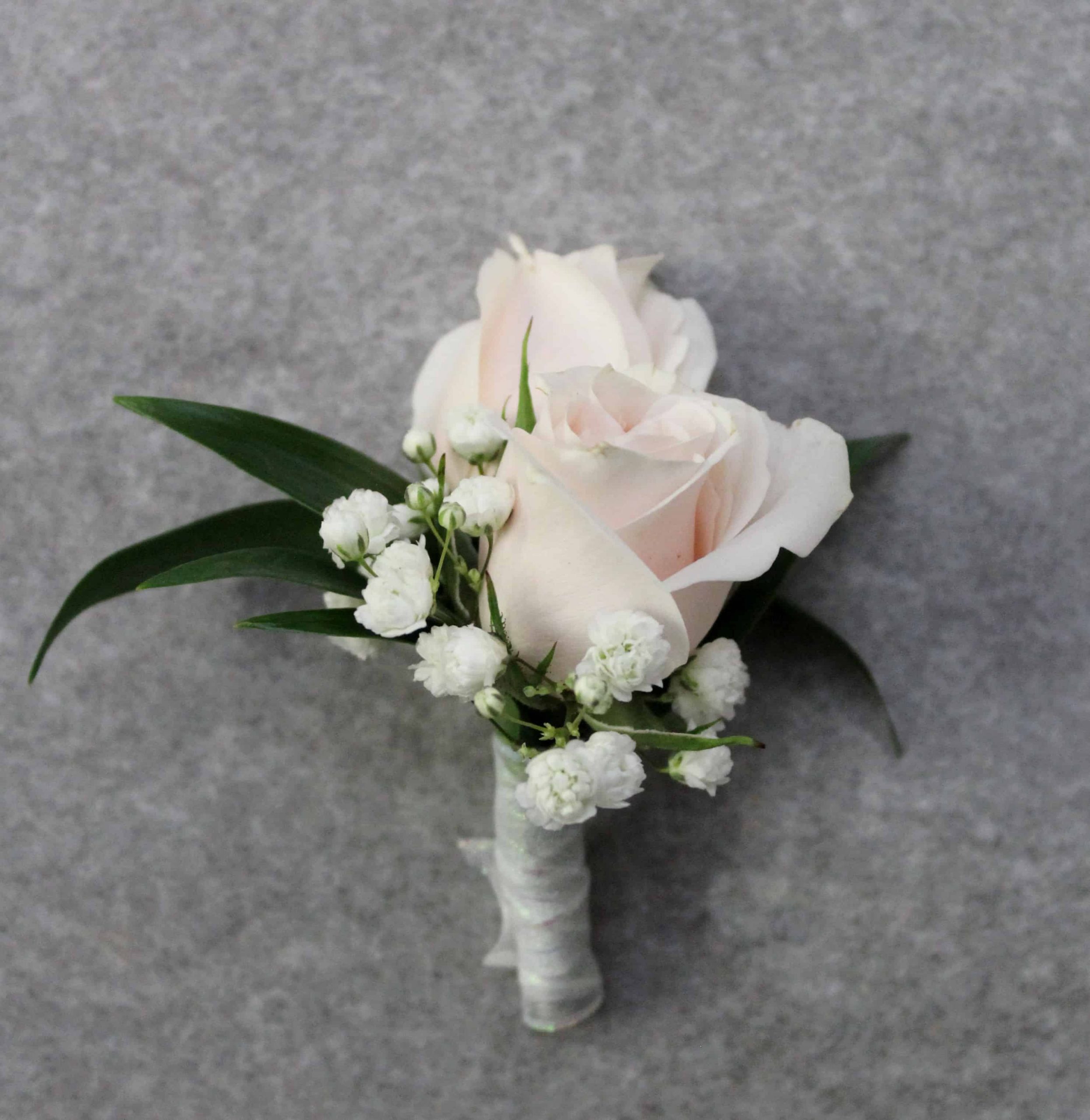 Double rose boutonniere with two petite rose buds by Studley Flower Gardens