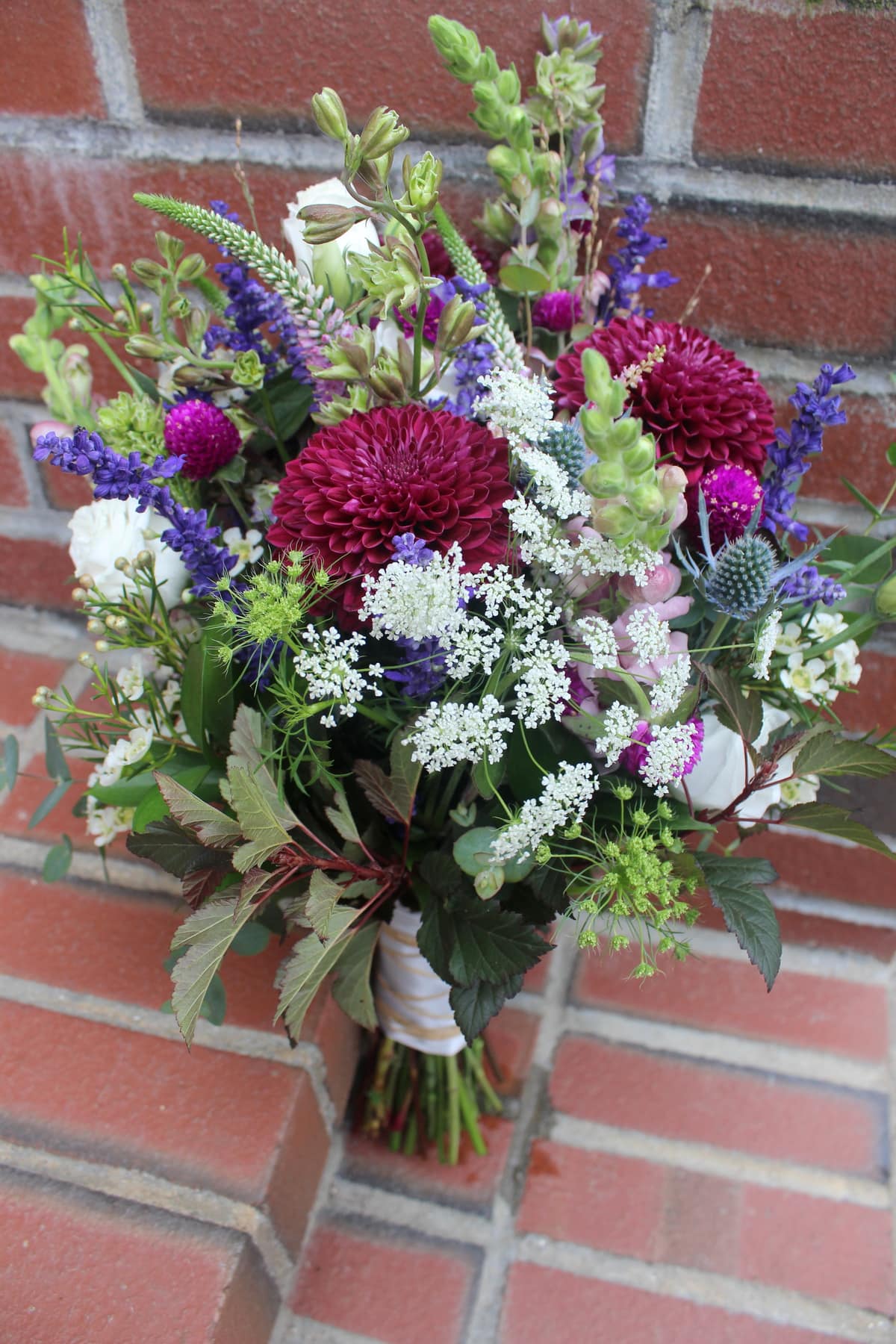 Dreamy Meadow Bouquet with deep pink and blue tones by Studley Flower Gardens