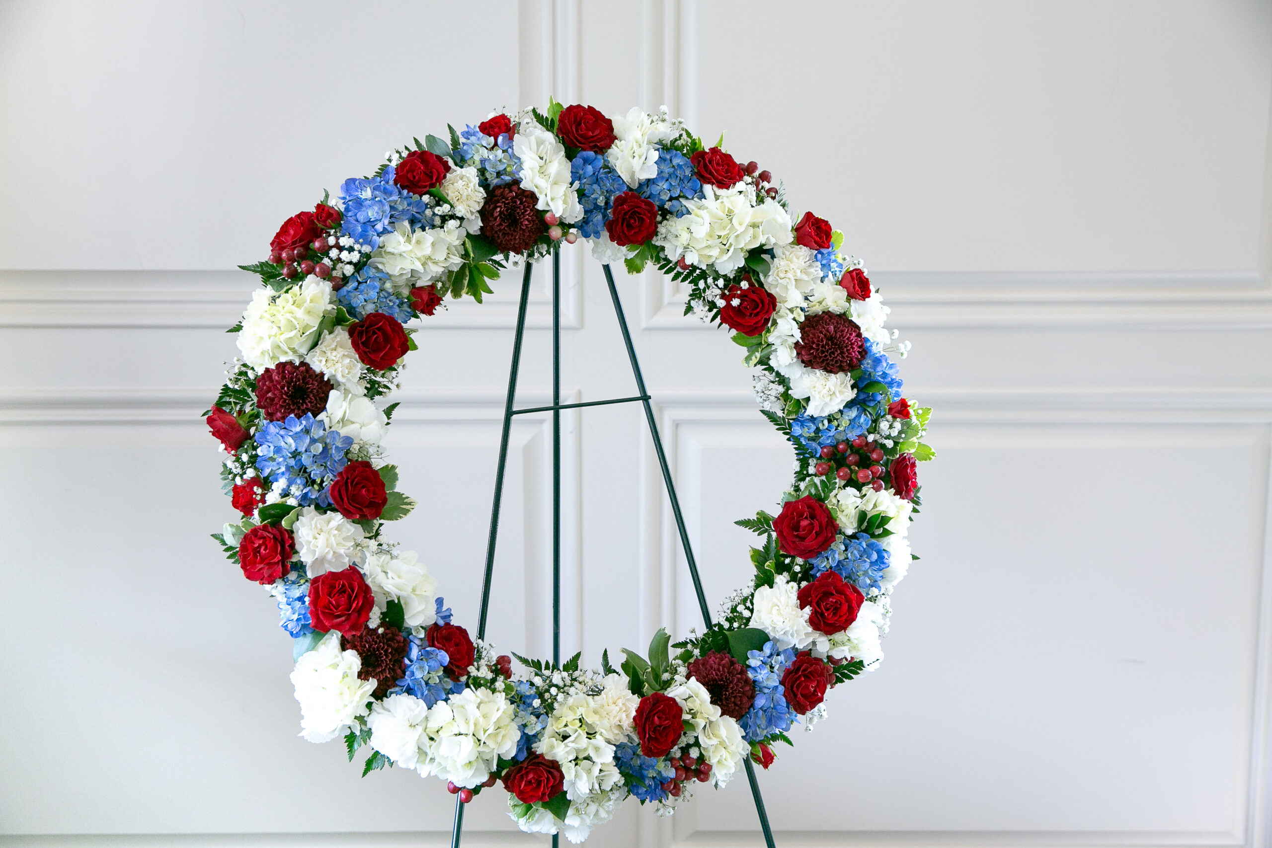 Forever Honored Bouquet wreath with red, white, and blue blooms by Studley Flower Gardens