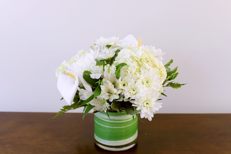 Hope Bouquet by Studley’s with creamy white blooms and greenery by Studley Flower Gardens