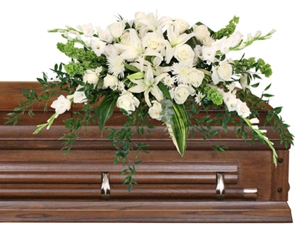 Hushed Goodbye casket spray with soft white flowers and greenery by Studley Flower Gardens