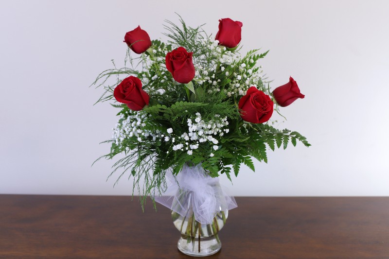 Six red roses bouquet with a much love design by Studley Flower Gardens