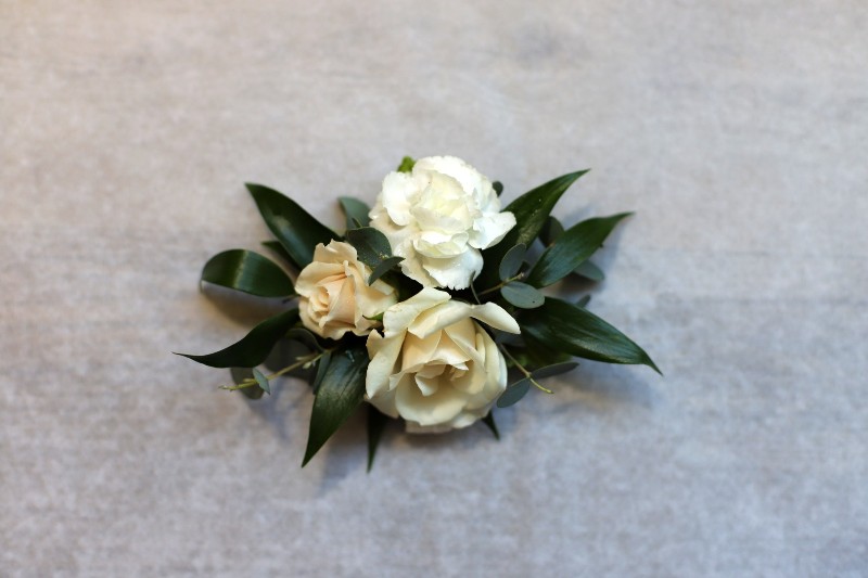 White New Look corsage with emerald green foliage by Studley Flower Gardens