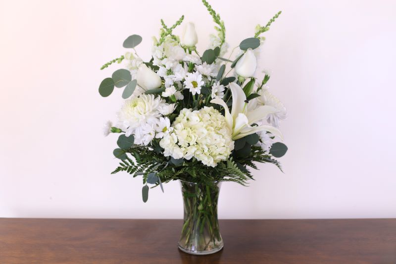 Quiet Grace Bouquet lush white hydrangea lilies and daisies in glass vase by Studley Flower Gardens