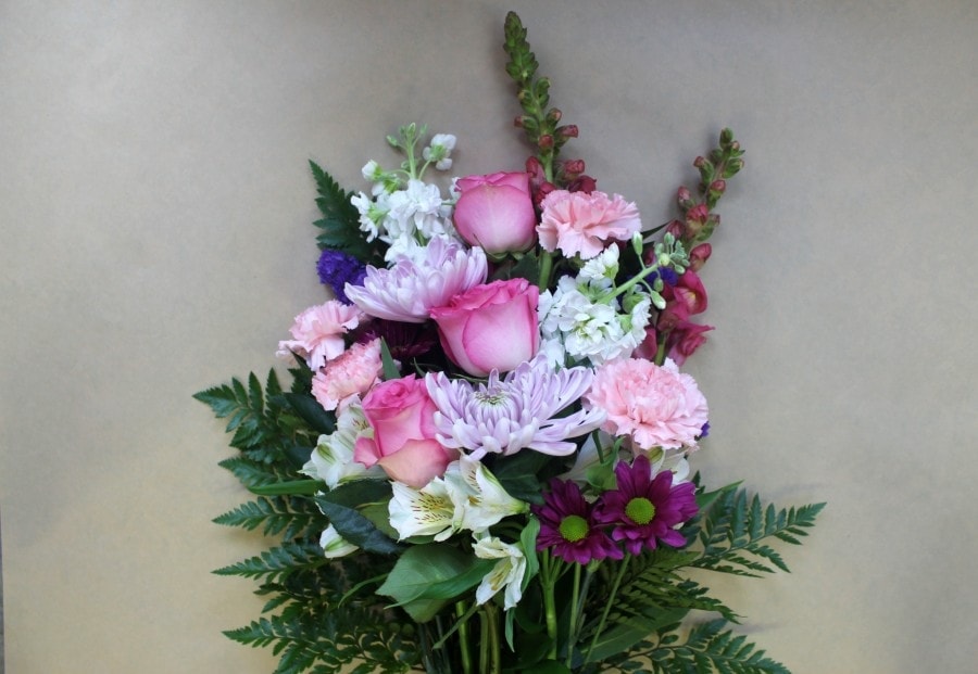 Rosy Dawn wrapped bouquet with pink blooms by Studley Flower Gardens