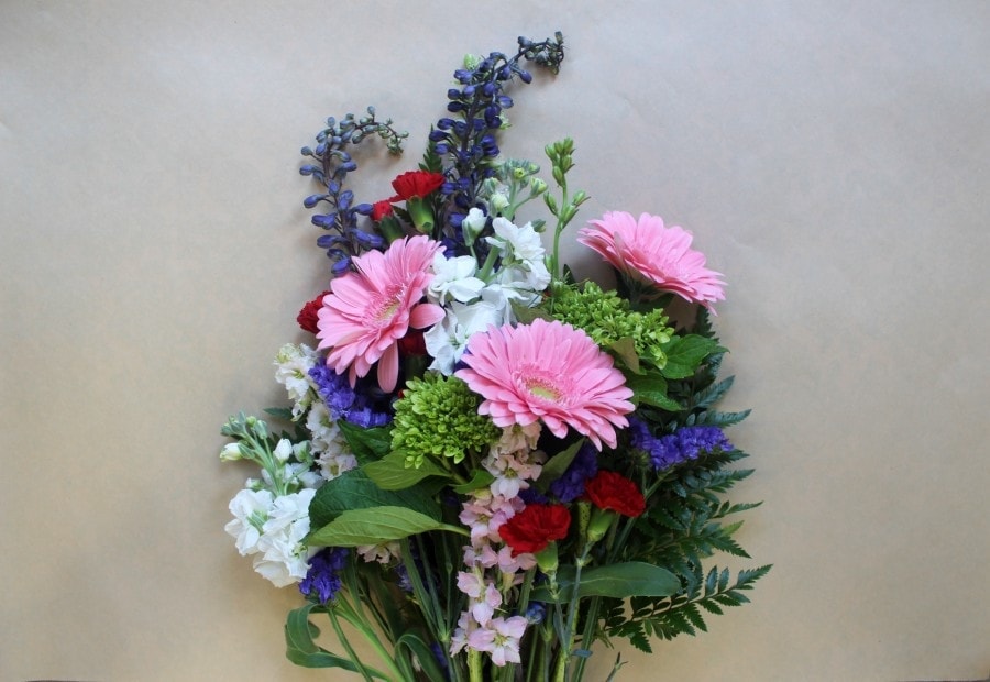 Secret Garden wrapped bouquet with soft garden blooms by Studley Flower Gardens