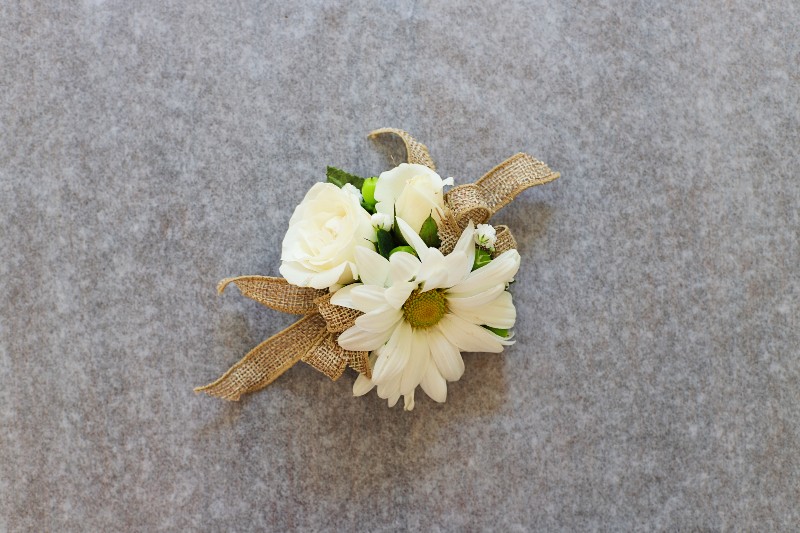 Sweet Daisy Corsage with crisp white daisies and roses by Studley Flower Gardens